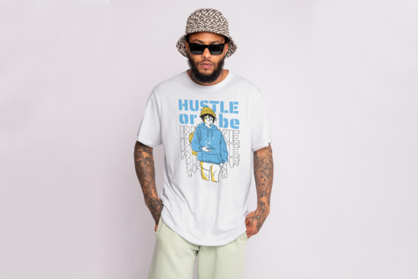 shirtsbarn anime-themed t-shirt Hustle or be broke worn by a model wearing a hat and smiling.png